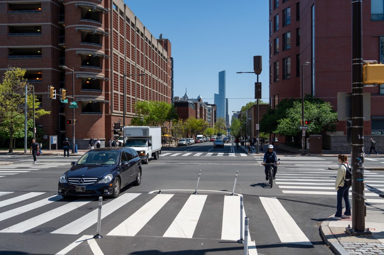 View of Walnut St looking east at the intersection with 38th St. There is a buffered bicycle lane and fresh crosswalk pavement markings.